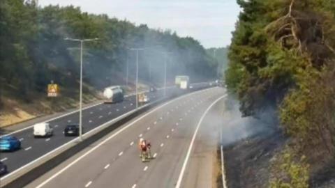 Two carriageways traveling northbound and southbound. the right hand side shows no cars at all, while the left hand side shows some cars driving down