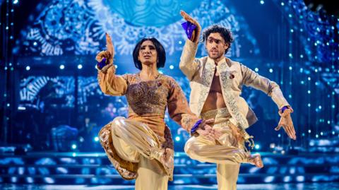 People: Balvinder Sopal & Julian Caillon strike a pose with one leg crossed.