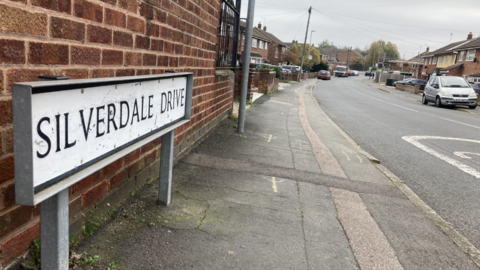 View looking down Silverdale Drive with the street sign prominent in the foreground