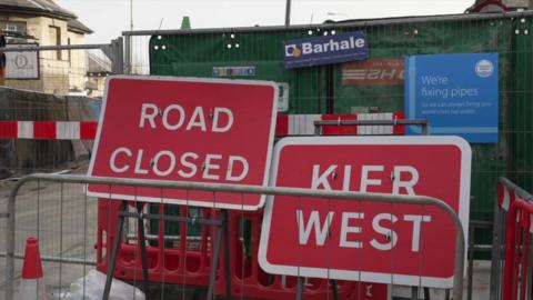 Road signs and barriers on the Botley Road. The road signs read "Road Closed" and "Kier West". There is a cone on the road as well.