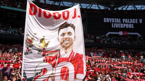 Liverpool fans holding up a banner in tribute to Diogo Jota during their Community Shield match against Crystal Palace.