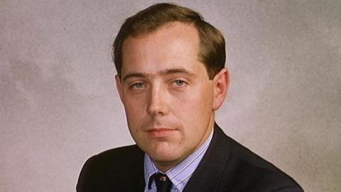 Sir Peter Luff as a younger man. He has short brown hair and is wearing a dark suit in a formal portrait-style photograph.