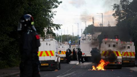 Large police presence and fire on road