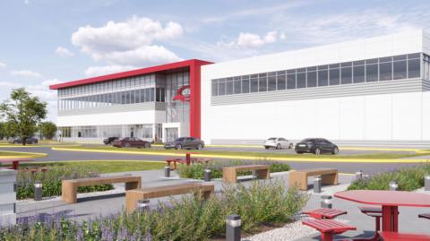 A computer-generated image of how the QTS data centre might look: benches and picnic tables stand among shrubs in the foreground. In the background is a large, red and white rectangular building with a row of windows running along its second storey. Cars are parked outside.