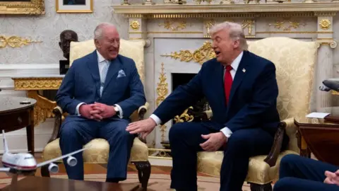 The King laughs as Donald Trump touches his thigh while the pair meet in the Oval Office.