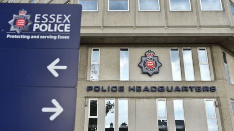 The outside of Essex Police HQ, a large, grey-stoned building with "Police Headquarters" written on the front. 