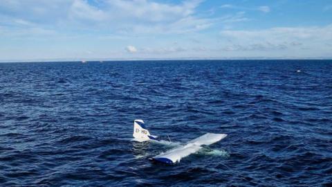 Small aircraft in the sea partially submerged