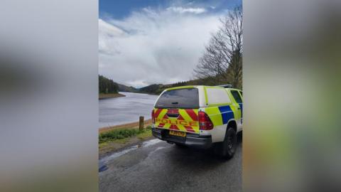 Police vehicle in front of water