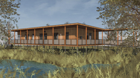 A CGI image of a wooden building built over the meadow.