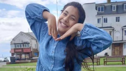 A photograph of Palwasha Akbar smiling for the camera