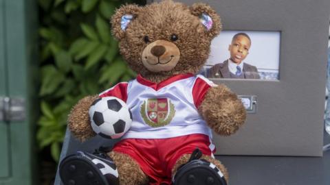 a teddy bear in an Arsenal kit was laid at the vigil for Daniel