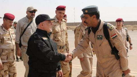 Twitter image of Haider al-Abadi shaking hands with Iraqi fighters