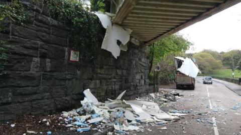 Lorry debris under bridge