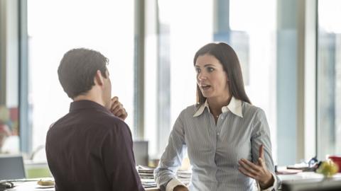 Man and woman talking in an office