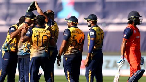 Dasun Shanaka and Maheesh Theekshana of Sri Lanka celebrate with team mates after taking the wicket of Vikram Singh