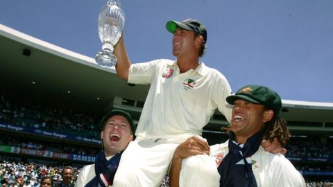 Shane Warne being held up by Michael Clarke (L) and Andrew Symonds after the 2007 Ashes whitewash