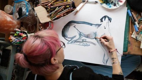 Harriet sketching a dog