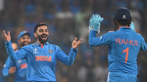 Virat Kohli celebrates taking a wicket