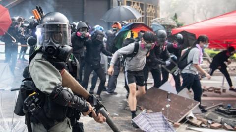 Protesters clash with armed riot police outside Hong Kong Polytechnic University