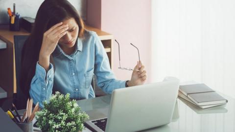 Stressed woman at computer