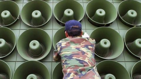 A South Korean soldier takes down a battery of propaganda loudspeakers on the border with North Korea in Paju on 16 June 2004
