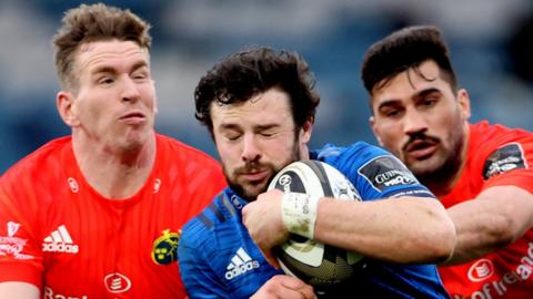 Munster's Chris Farrell (left) and Damian de Allen (right) tackle Leinster's Robbie Hensaw
