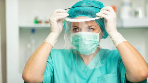 A medical professional wearing full PPE