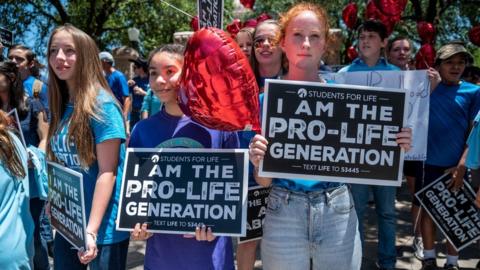 Pro-life protesters stand near the gate of the Texas state capitol at a protest on May 29, 2021 in Austin, Texas.