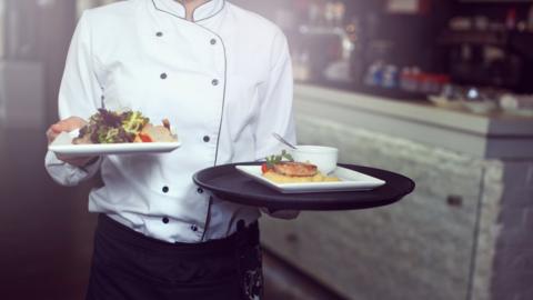 A waiter serving food