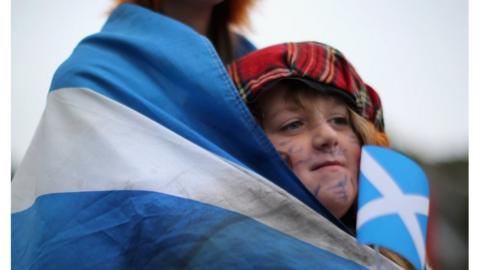 Debbie Ramsay, aged 24 and Gian Smith, aged eight, wait outside the Scottish Parliament