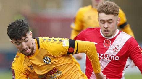 Finn Azaz of Newport County tries to keep Alfie McCalmont of Morecambe FC at bay