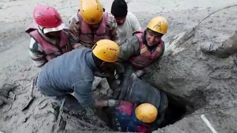 Emergency workers rescue the man from a tunnel