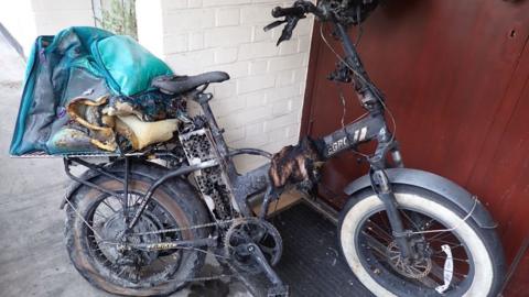 The burnt remains of an e-bike fire in September