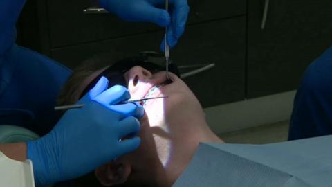 Dentist treating a patient with braces