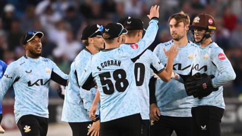 Surrey players celebrate a wicket at Sussex