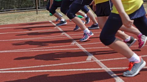 Generic shot of runners at the start line of an athletics track