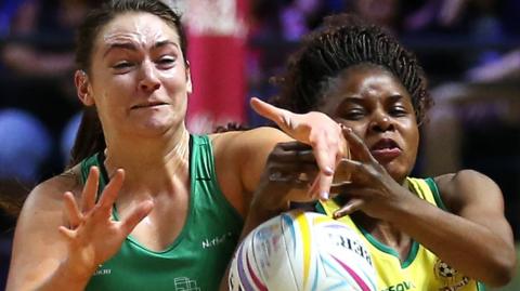 Northern Ireland's Emma Magee and Claris Kwaramba tussle for the ball