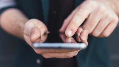 File photo of a close up of a mobile phone being held