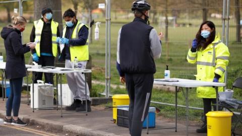 People take coronavirus tests on Clapham Common in London