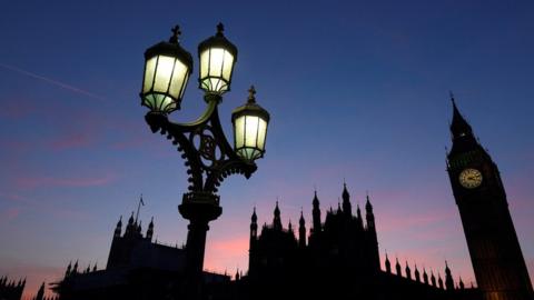 Dusk falls behind the Houses of Parliament