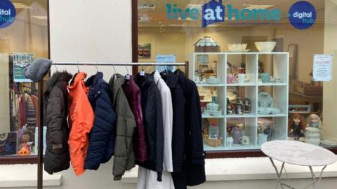 Coats on a rail outside the Live at Home charity shop