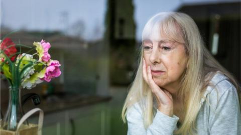 Woman looking out of a window