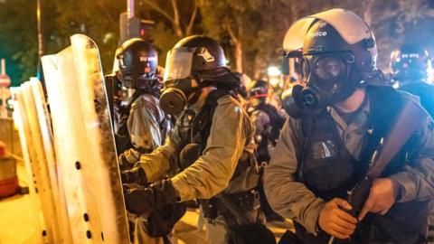 Riot police stand-off with protesters in the Kwai Fong district