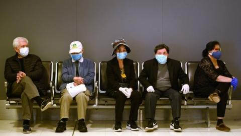 People wait to check in at Sydney airport