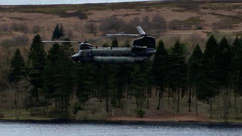 The Chinook helicopter flying over Derwent Reservoir in Derbyshire
