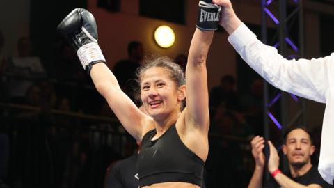Boxer Nina Hughes celebrates victory