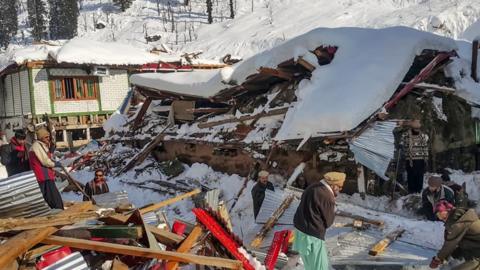 Villagers searching through rubble