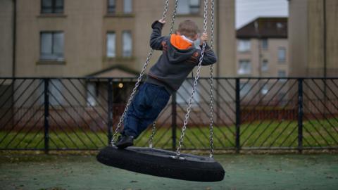 Child on a tyre swing