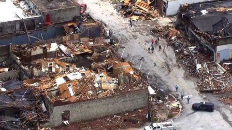 Aerial view of damaged buildings and debris scattered around