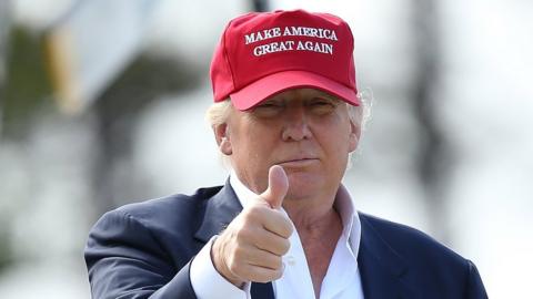 Trump does a thumbs up wearing 'Make America Great Again' hat